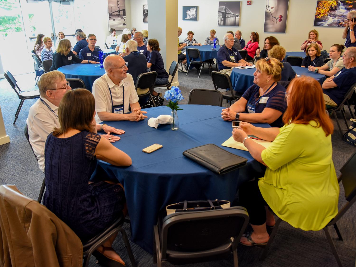 Several large tables with people around them at a luncheon