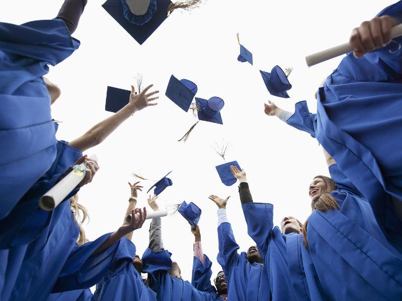 Graduates throwing their caps in the air