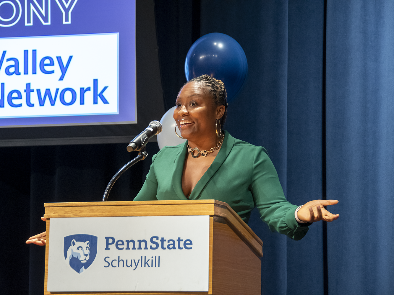 A female speaker at the podium.