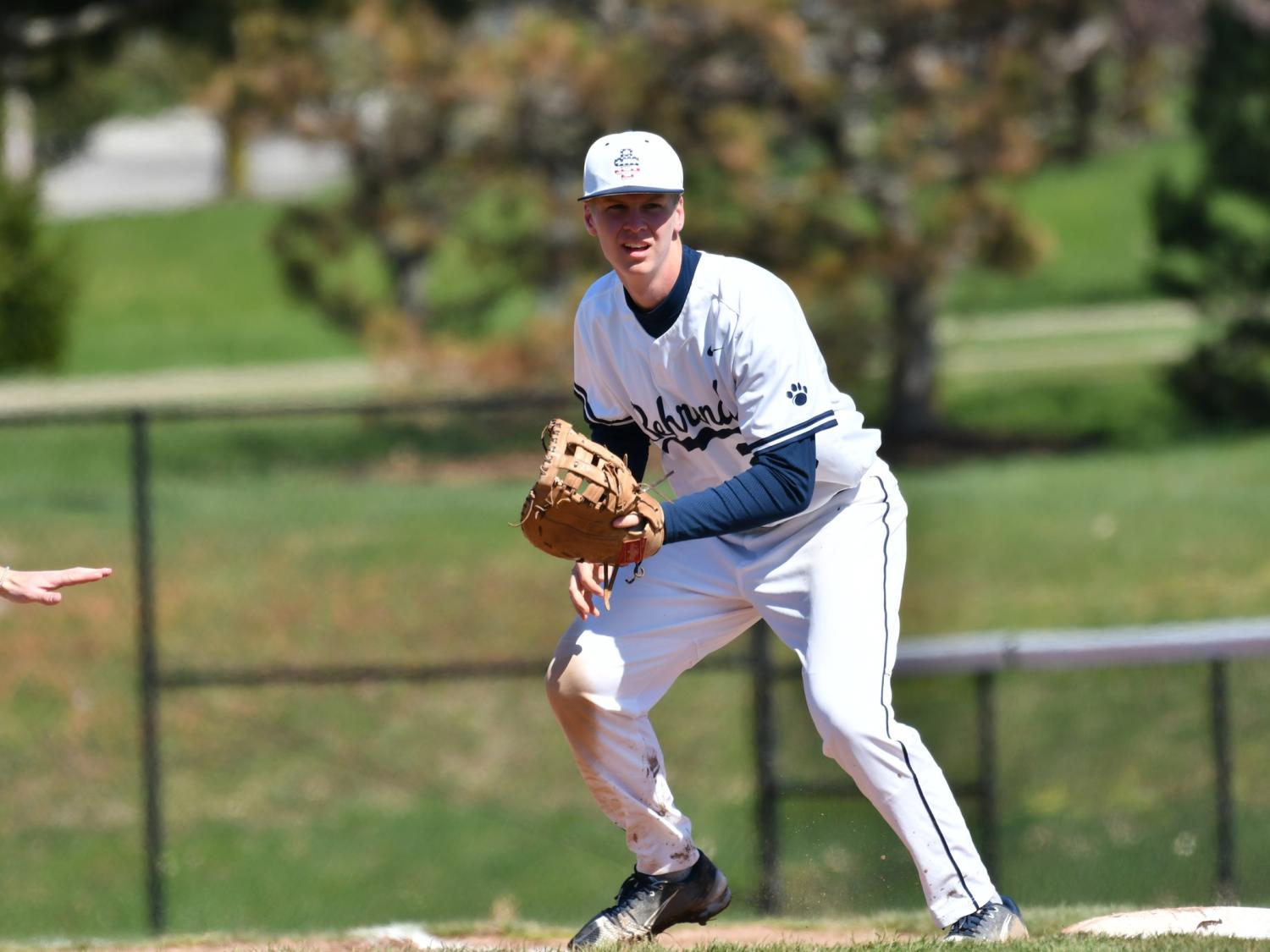 An infielder for the Penn State Behrend baseball team prepares to field the ball.