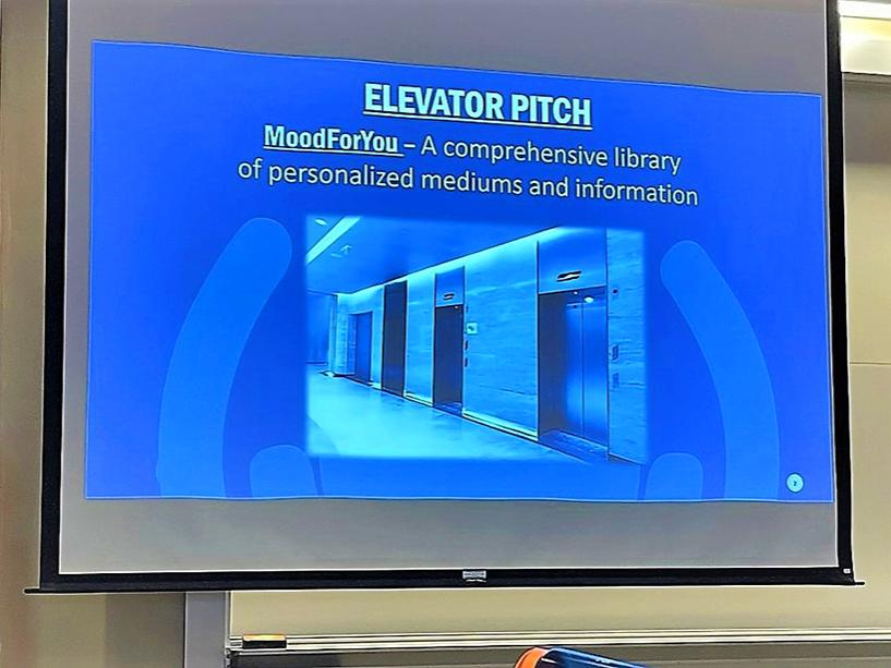 Two competitors present their Big Idea project via powerpoint to the audience