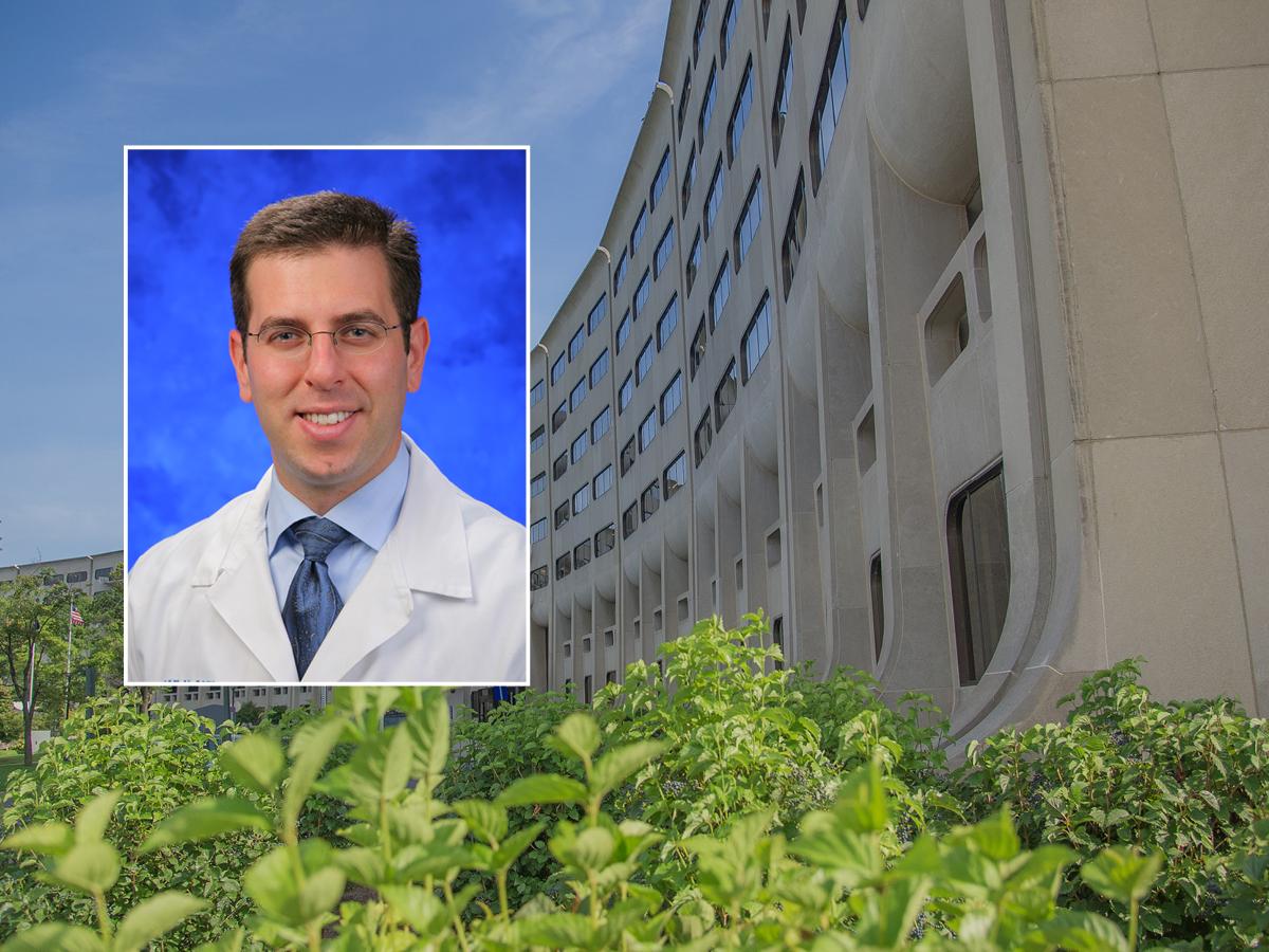 A head and shoulders professional portrait of Dr. Ian Paul against a background image of Penn State College of Medicine