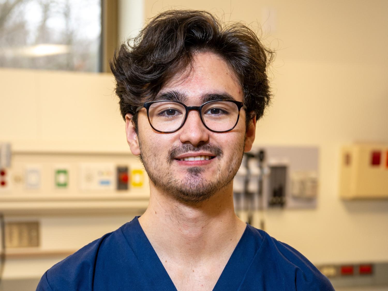 A portrait of Penn State Behrend graduate Grant Oishi in the college's nursing simulation lab.