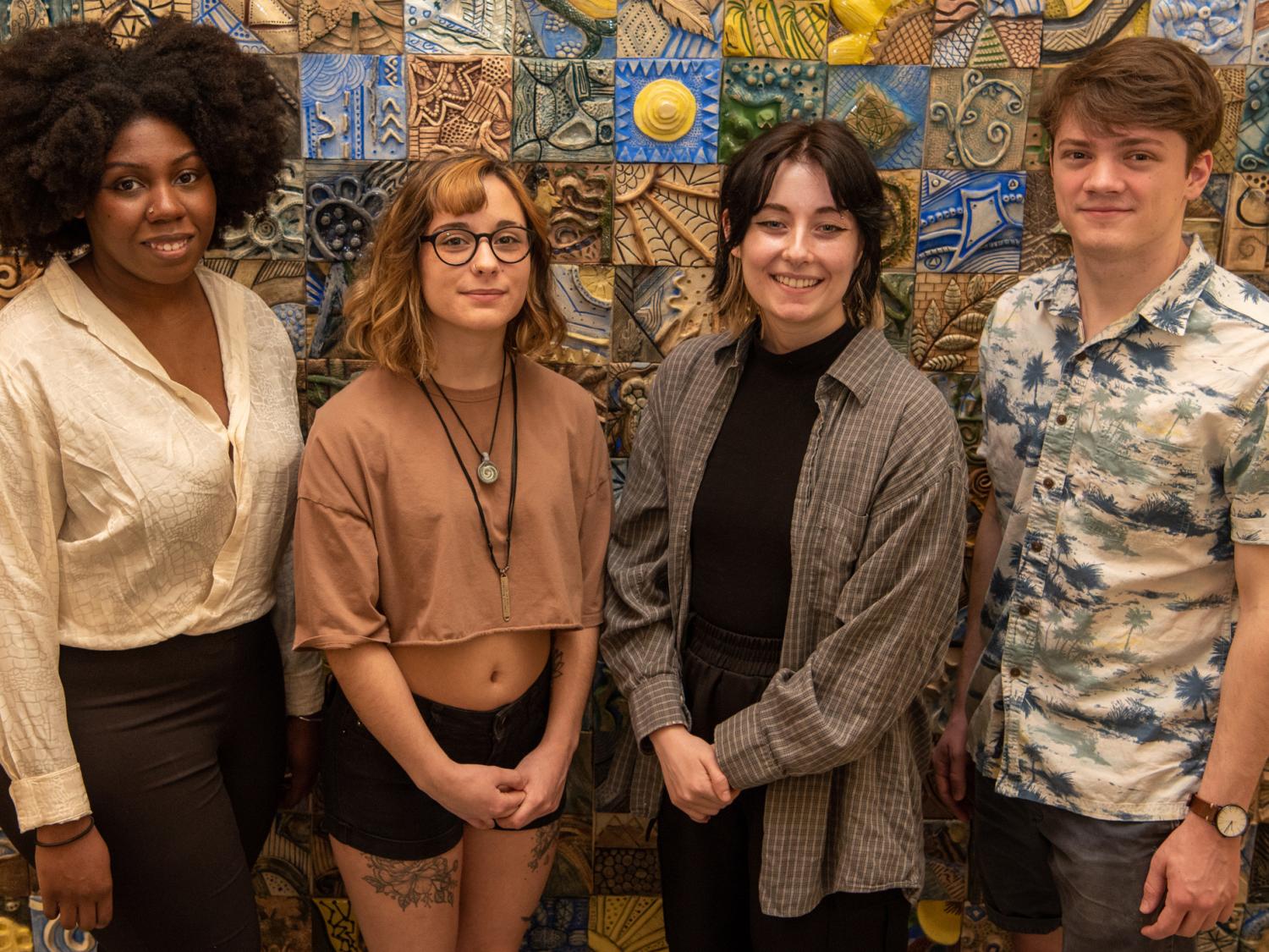 Four people posting for a photograph