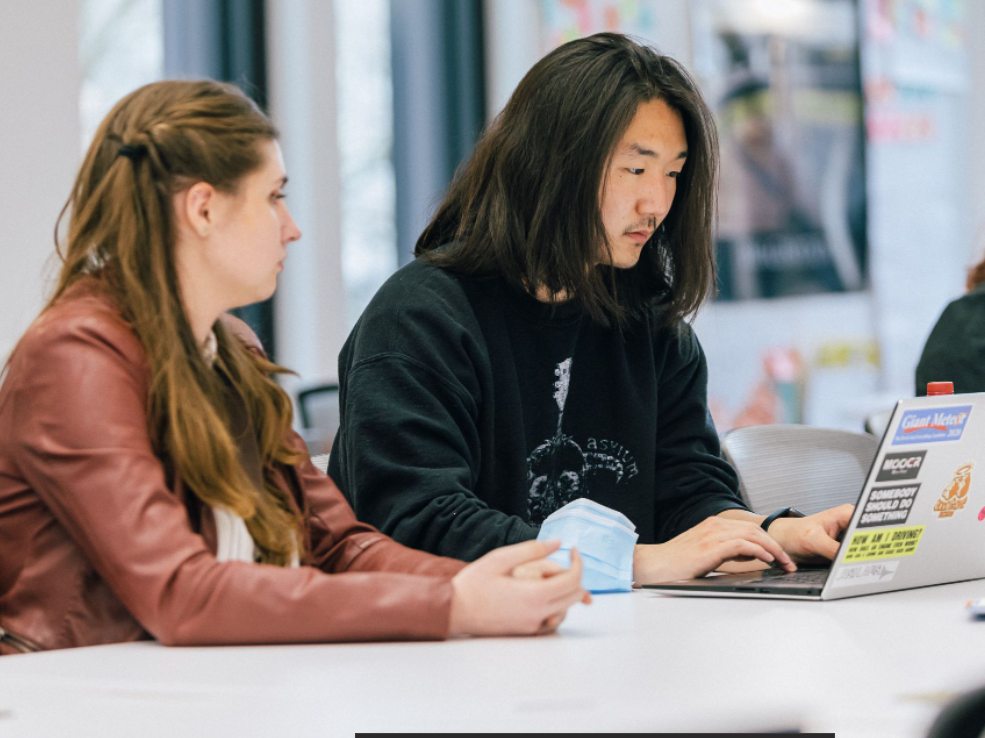 Two founders work together at a table