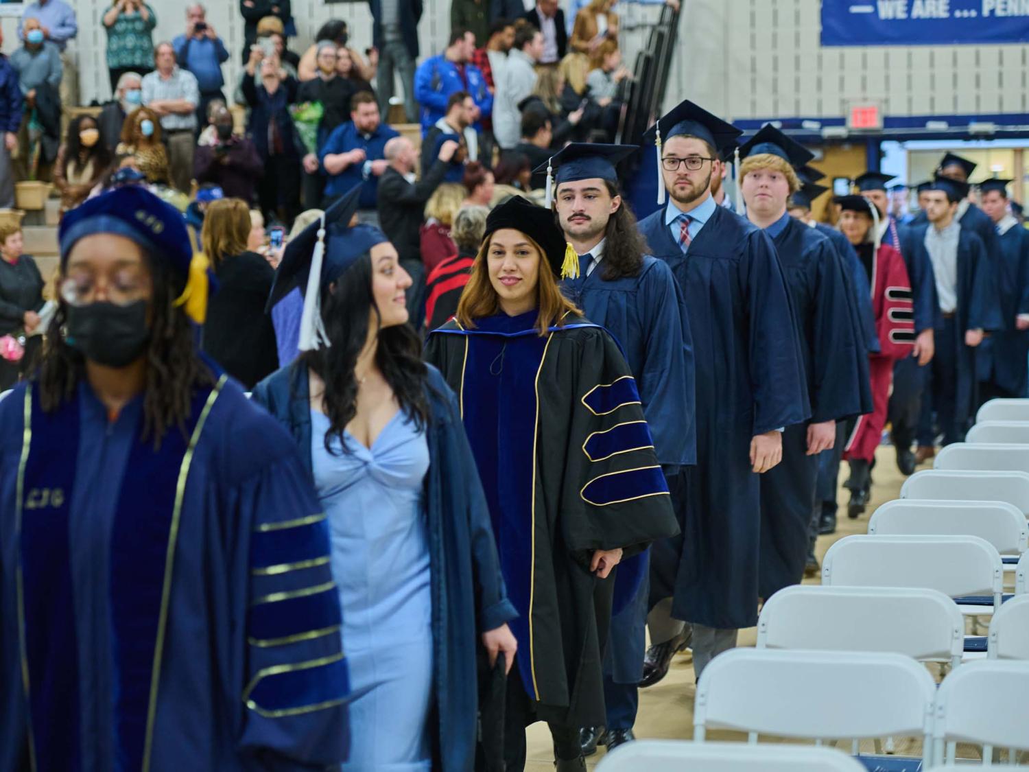 Students and professors walk into the campus gym.