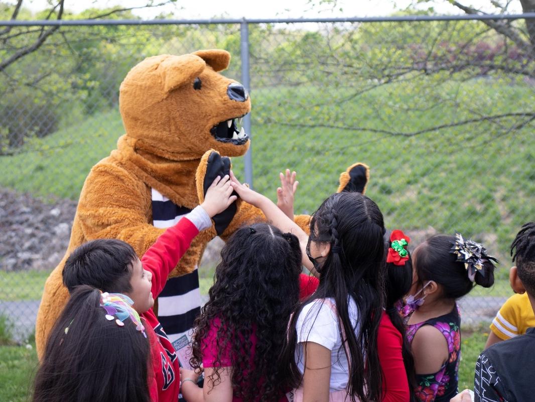 The Nittany Lion offers high fives to kids from Hancock Elementary School.