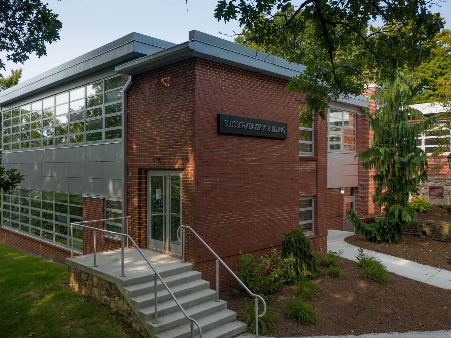 Brick building with trees surrounding it.