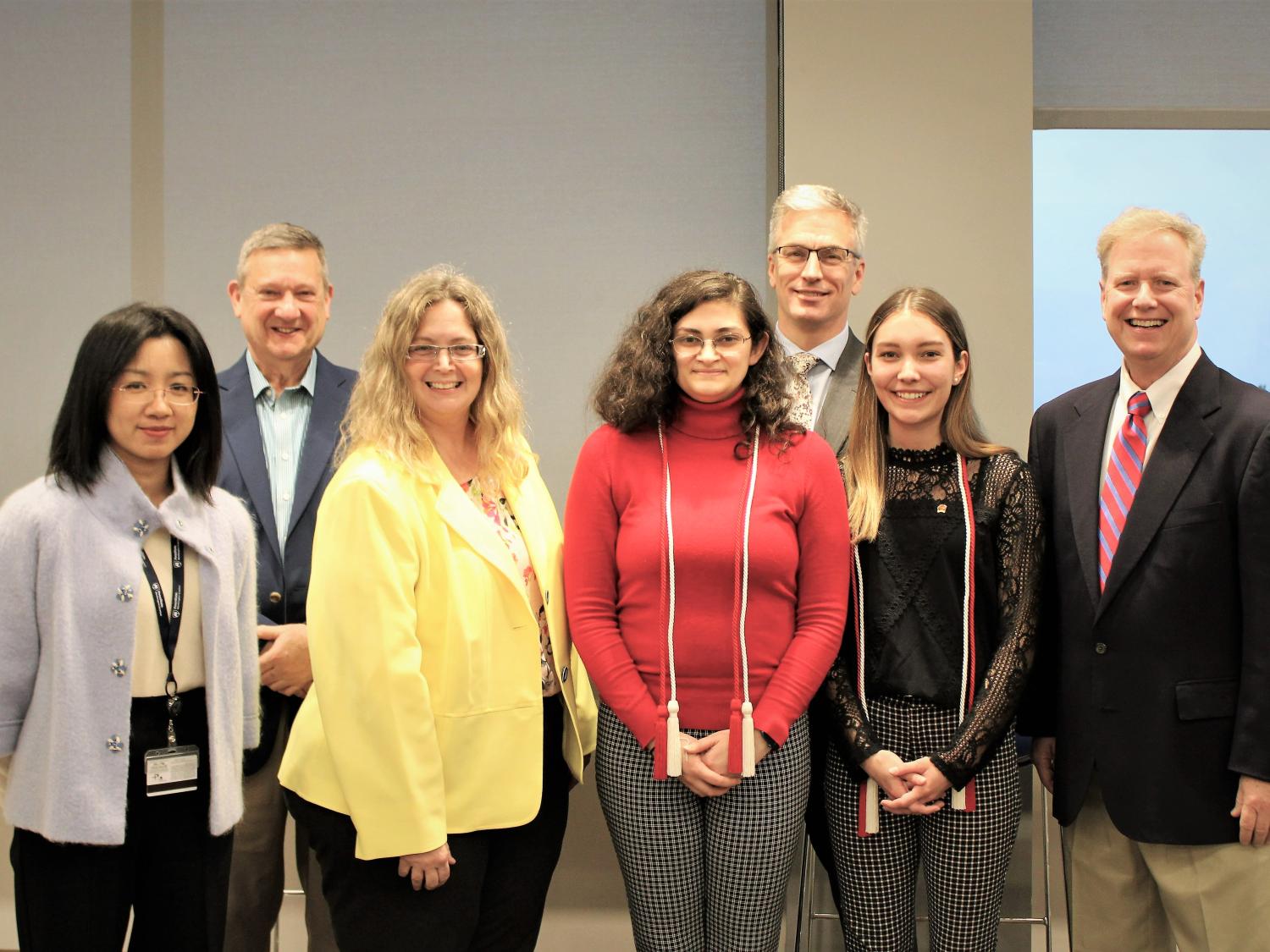 Lambda Pi Eta honor cord recipients pose with faculty members after cording ceremony
