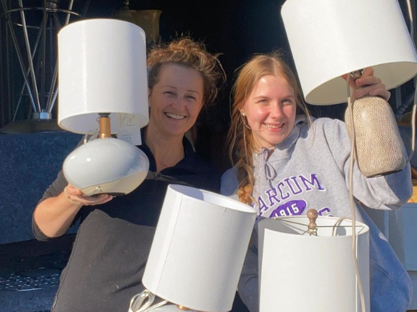 Mel McDaniel stands with a Marvin's Home volunteer, both holding white lamps