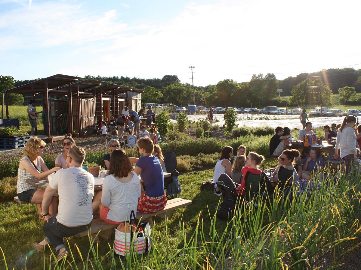 People sitting and watching music at the Student Farm