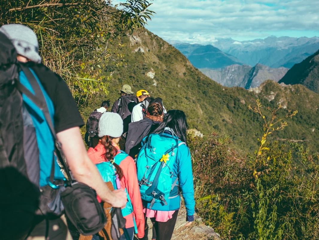 Large group hiking in a mountainous landscape. 