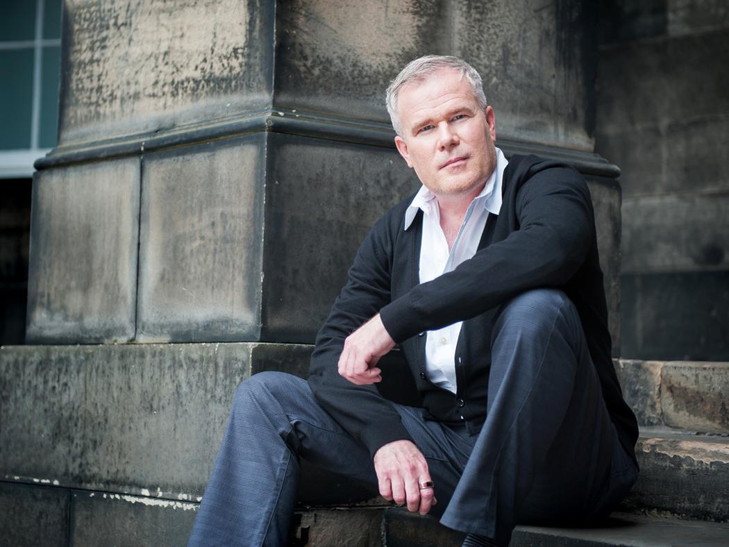 Photograph of Paul Daniel Marriott sitting on steps of a building.