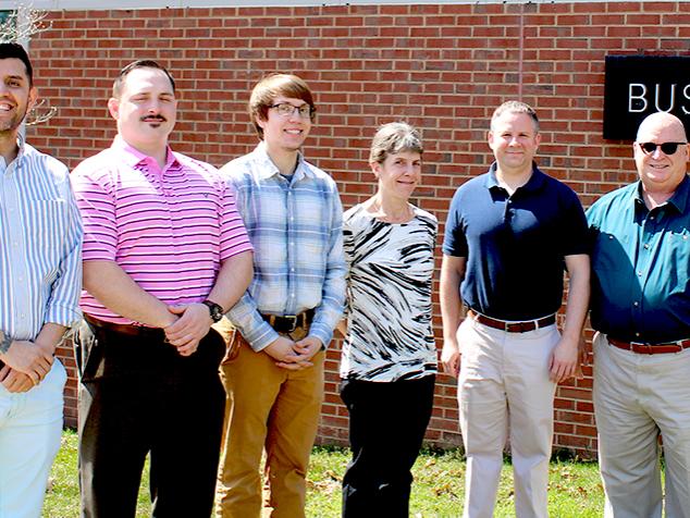 scranton business club members pose for a photo in front of business building