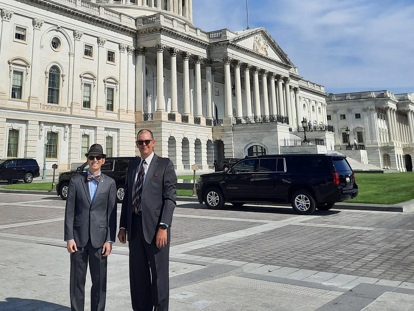 Two men stand outside the U.S. Capitol building