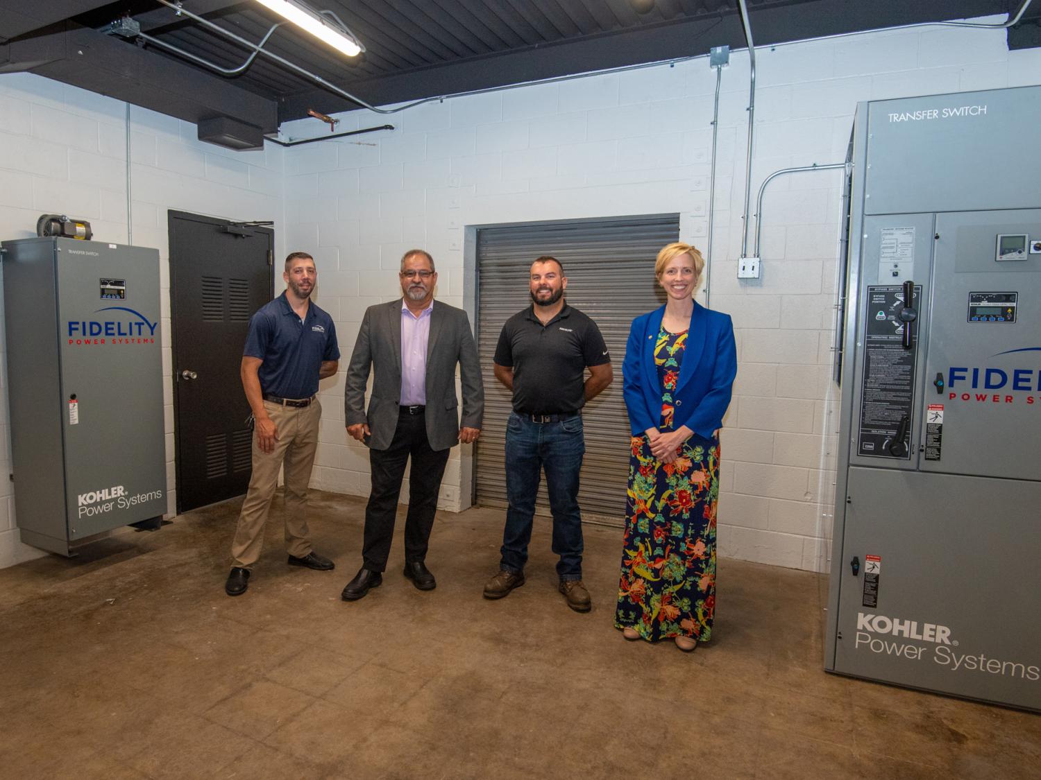 People standing between two of the three KOHLER units donated by Fidelity Power Systems to Pennsylvania College of Technology