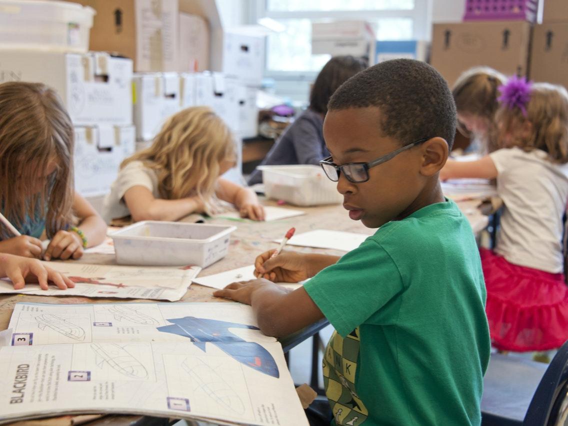 Boy in green shirt in classroom