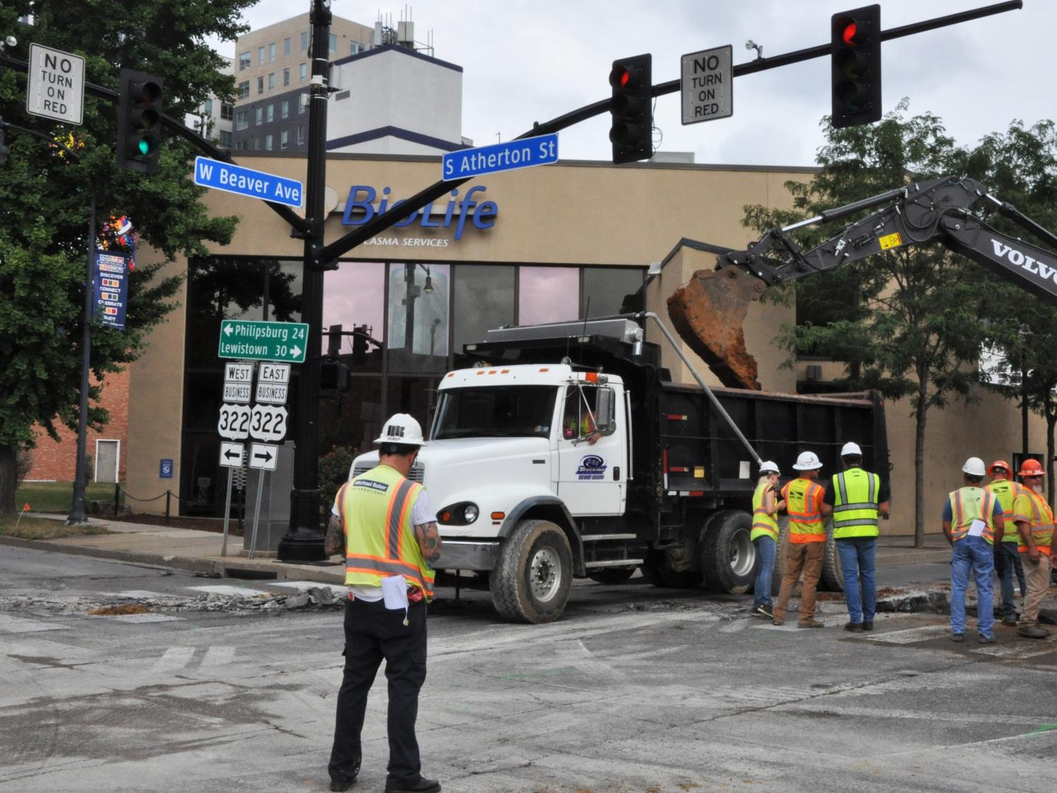 Construction crews work on maintenance on the intersection of Atherton Street and Beaver Avenue in downtown State College  