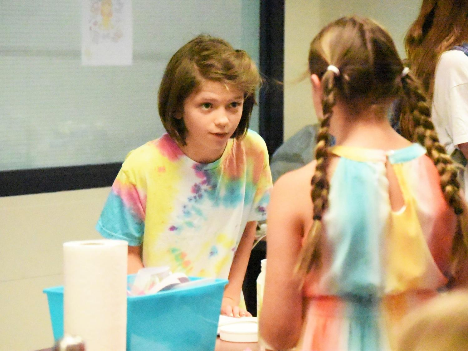 A 12-year-old girl interviews another student during a Penn State Behrend College for Kids program.