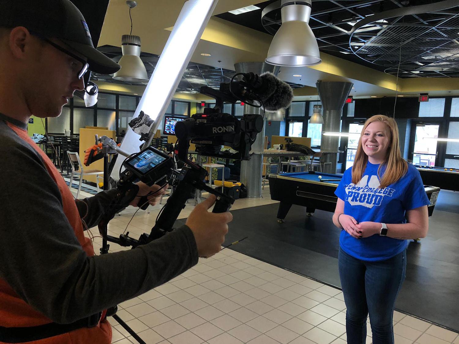 Student shares her college story in front of tv camera