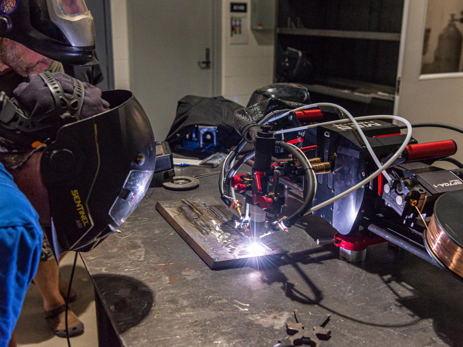 Students look at welding equipment in action