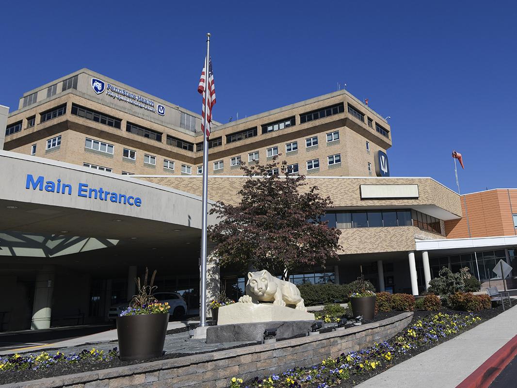 An external photo of Holy Spirit Medical Center, taken from the vantage point of the Main Entrance, which is in the foreground. The building's tower is in the backgroun and the Emergency Department is at right.