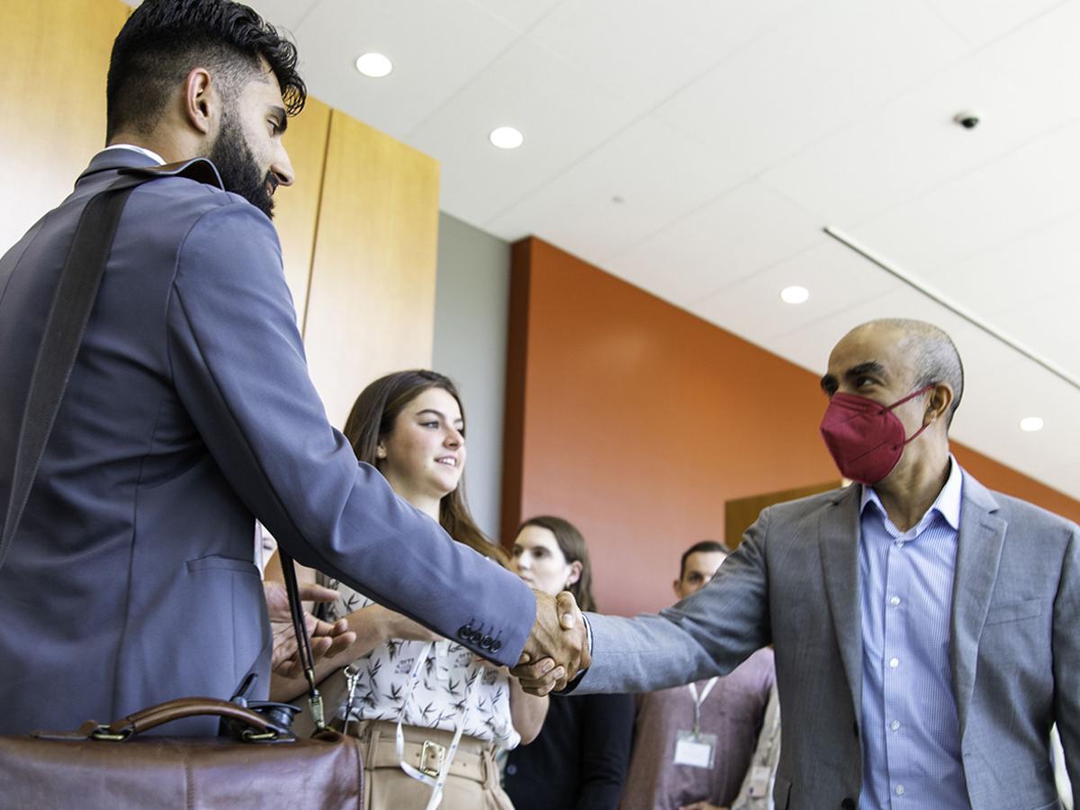 Student shaking professor's hand