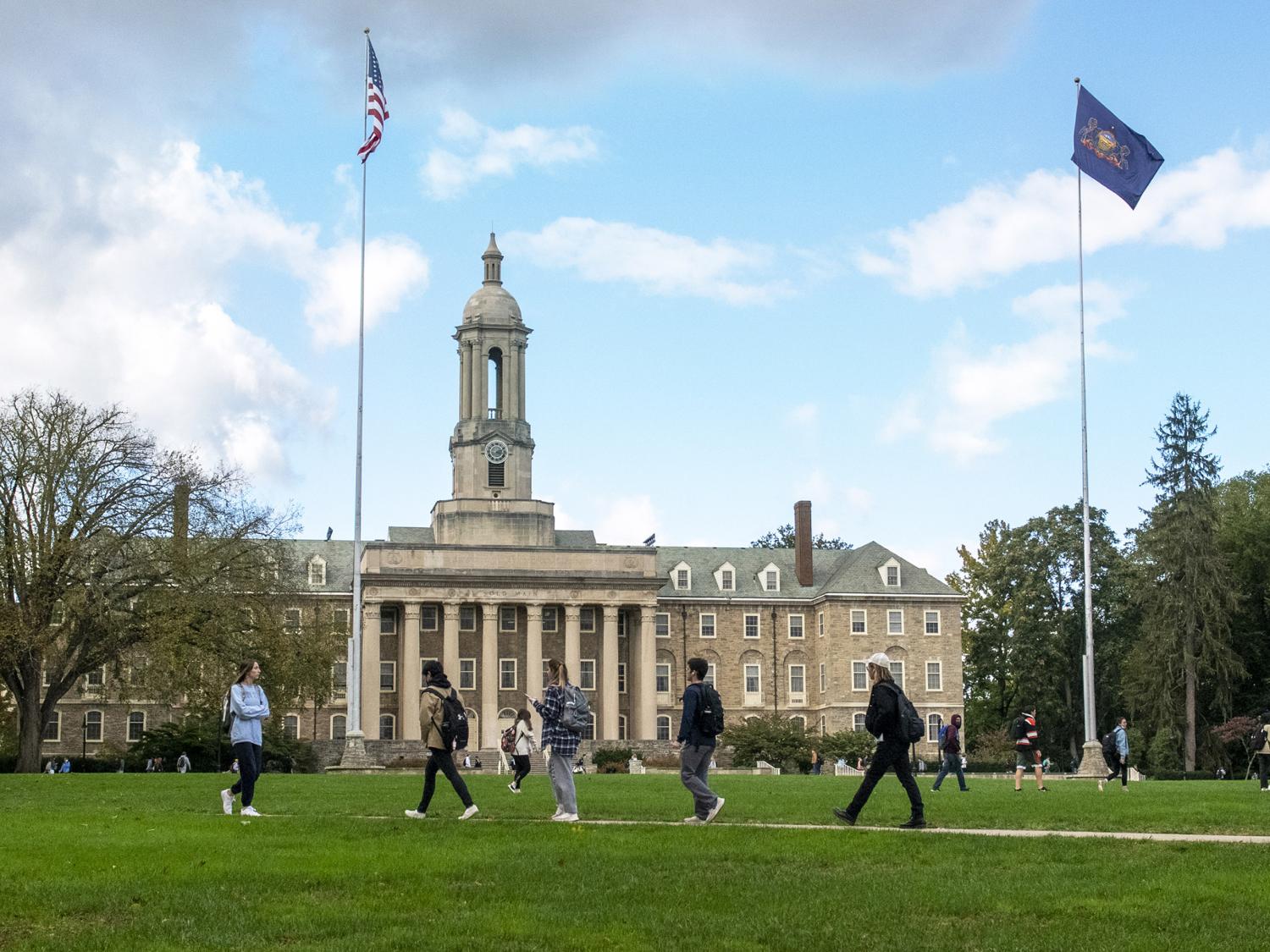students walking in front of Old Main