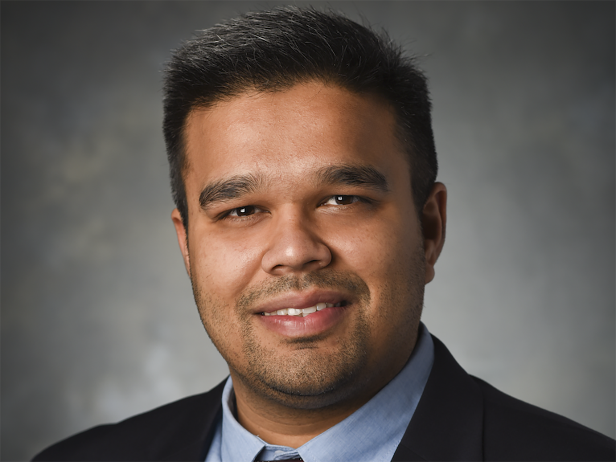 A headshot of Ankit Saxena wearing a suit and tie