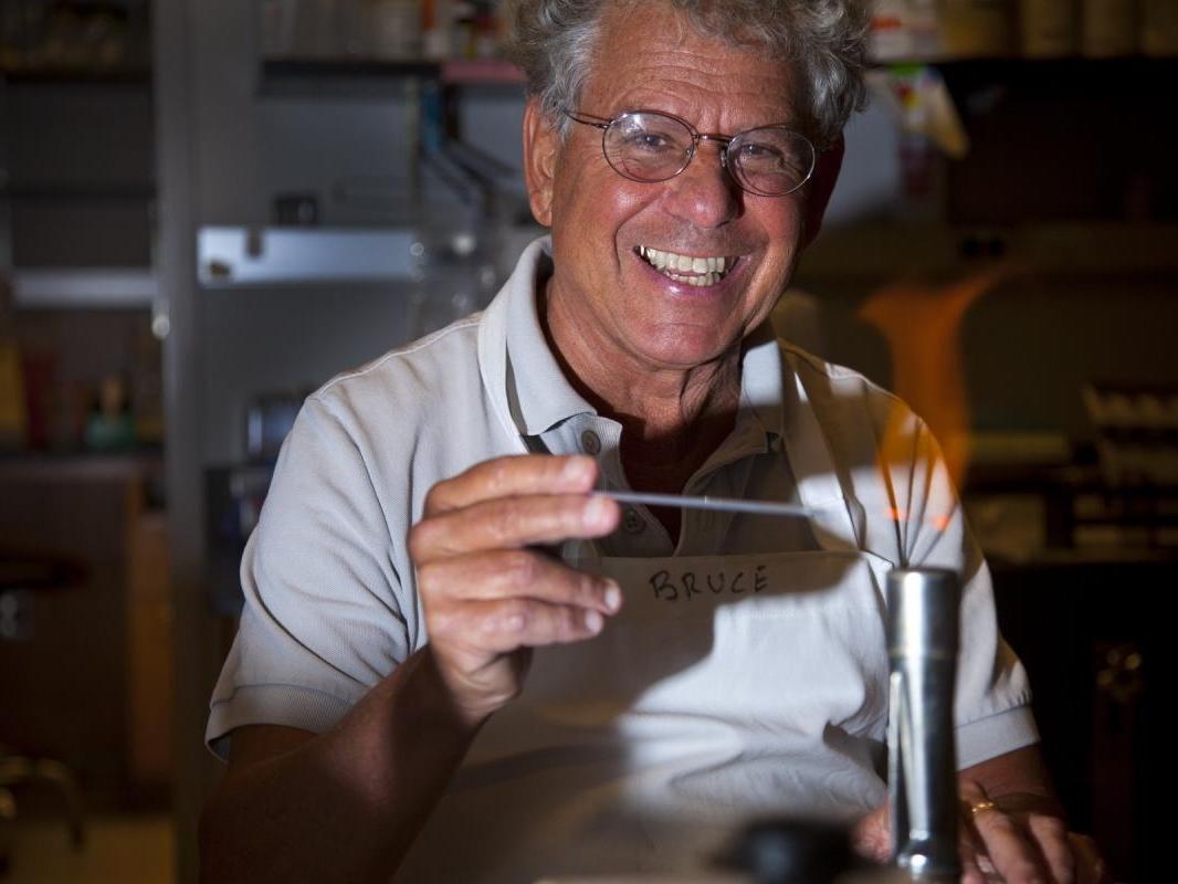 Bruce Levin holds item to bunsen burner