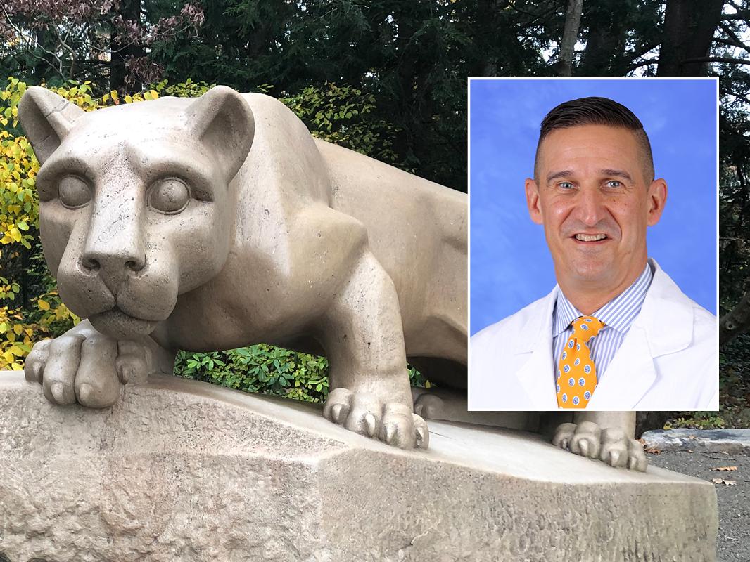 A head and shoulders professional portrait of Dr. Mark Stephens against a background image of the Penn State Nittany Lion Shrine in University Park. 