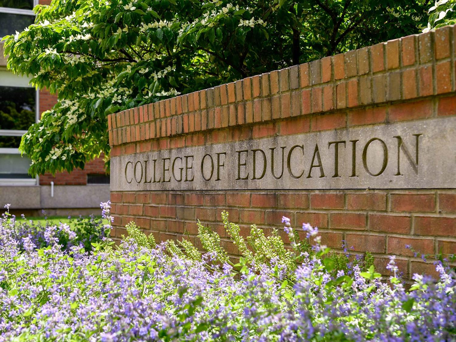 A brick wall sign says "College of Education"