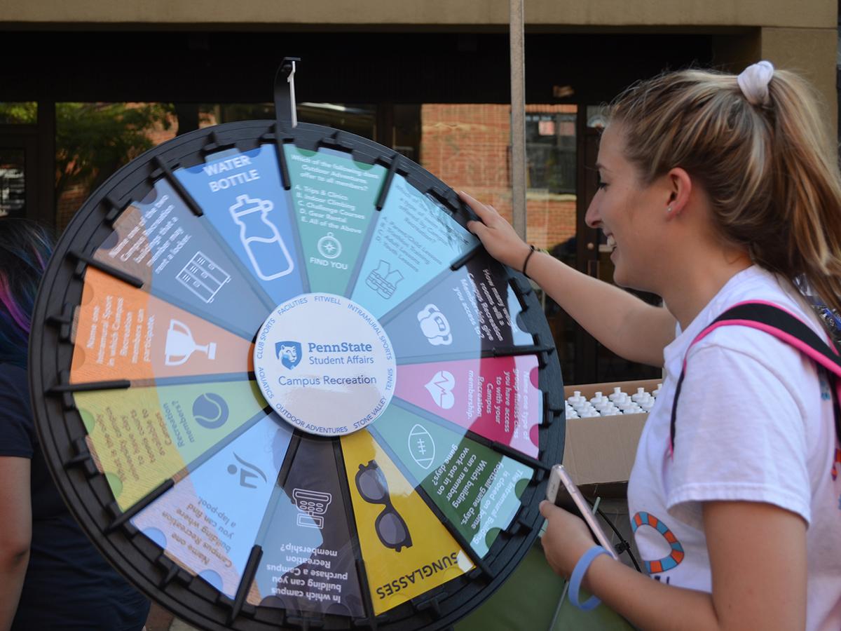student spinning a prize wheel