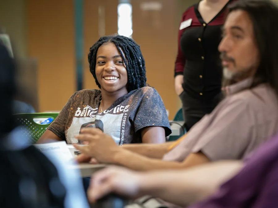 A first-year Penn State student in the Prehealth Summer Bridge Program smiles during a Lunch & Learn session with the Eberly College of Science's associate deans.