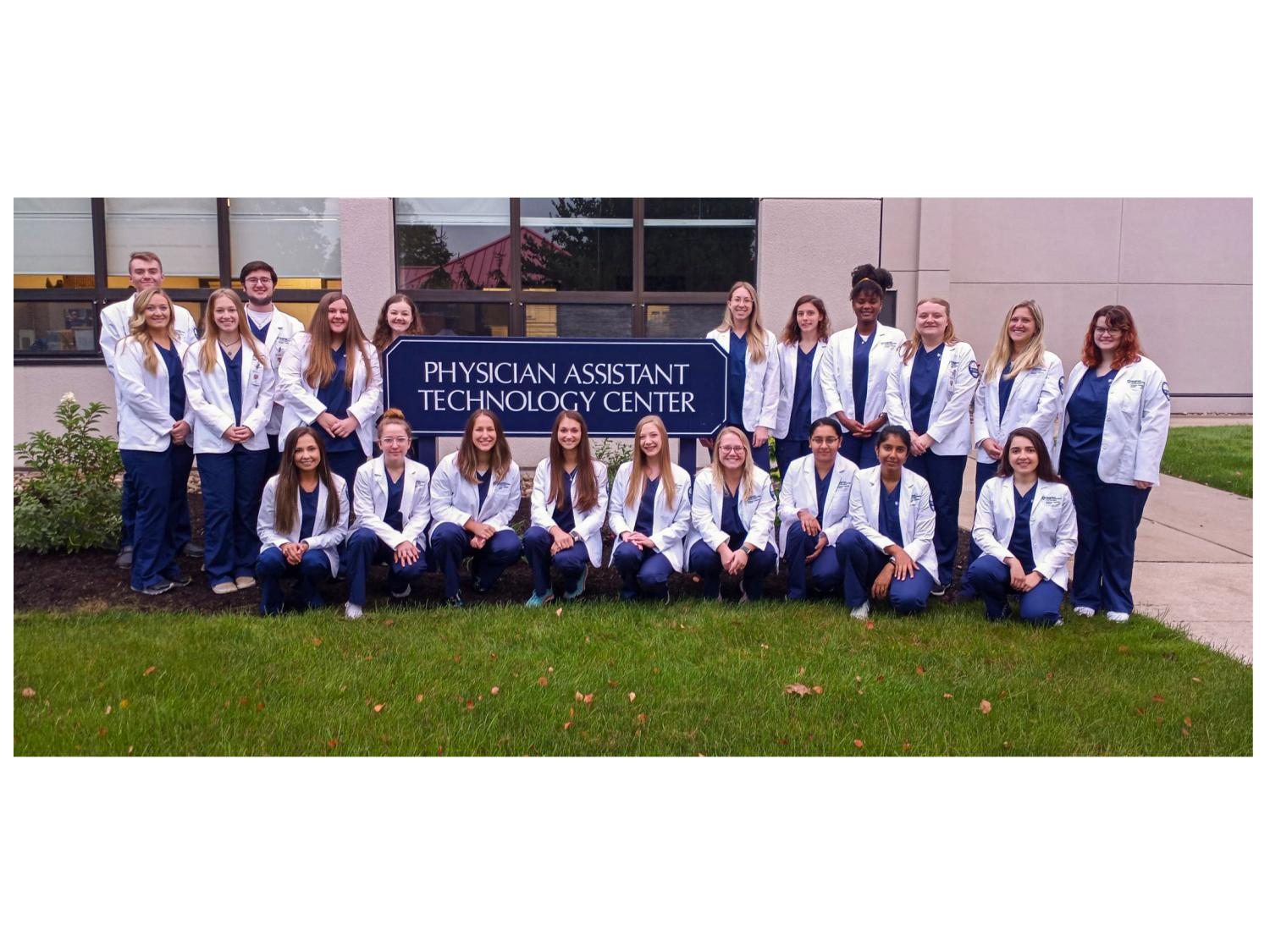 A group of students posing for a photograph outside of a building
