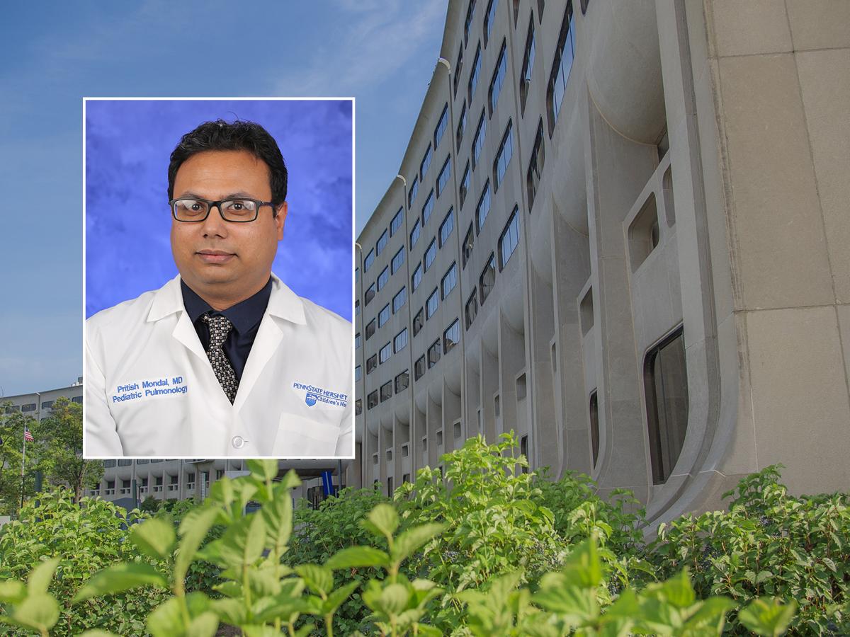 A head and shoulders professional portrait of Dr. Pritish Mondal against a background image of Penn State College of Medicine. 