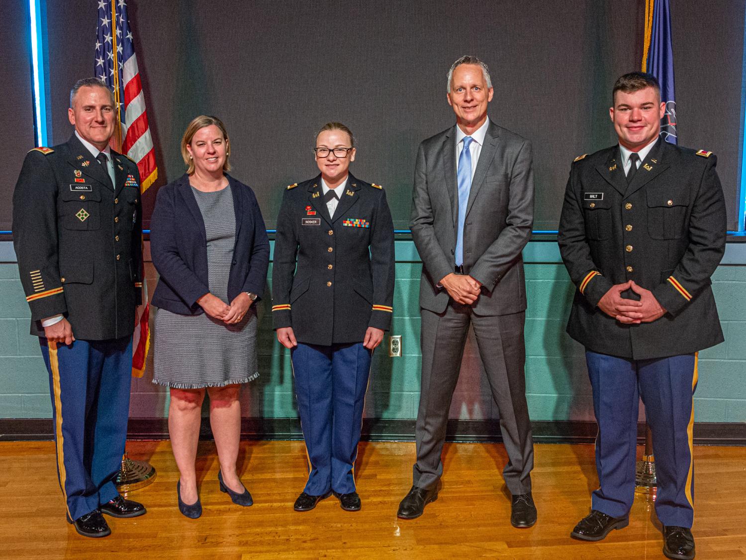 Army recruits stand with others for group photo