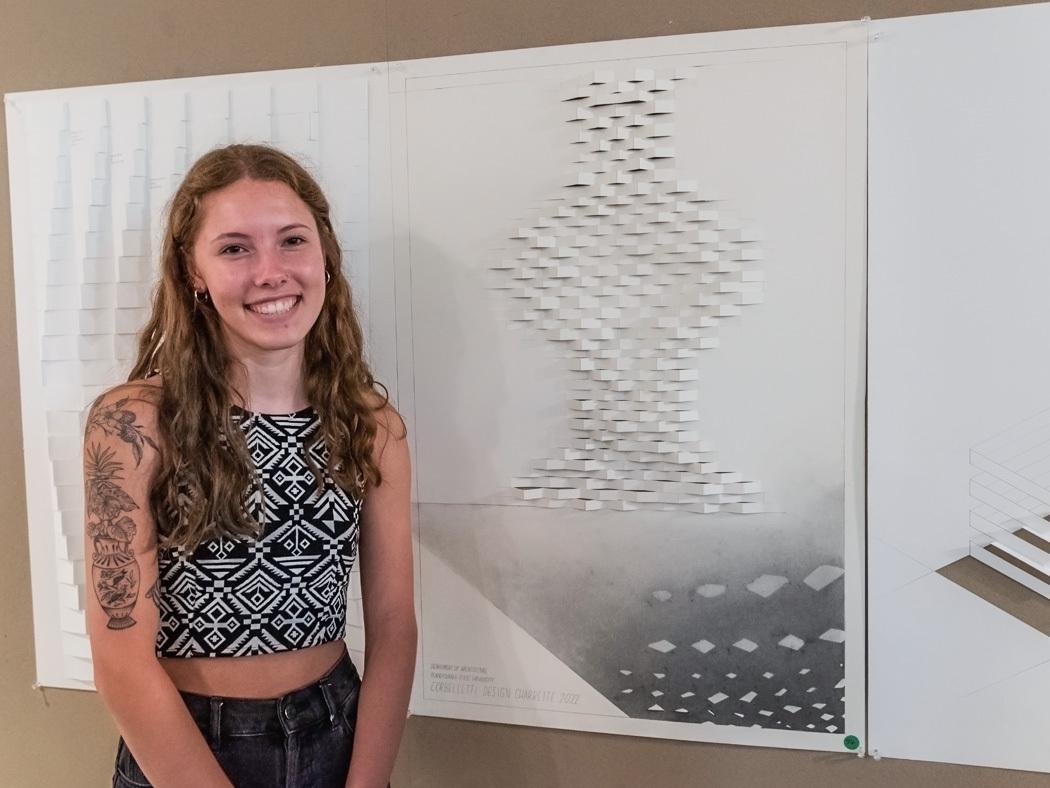 Sophie Marks stands next to her winning design. 