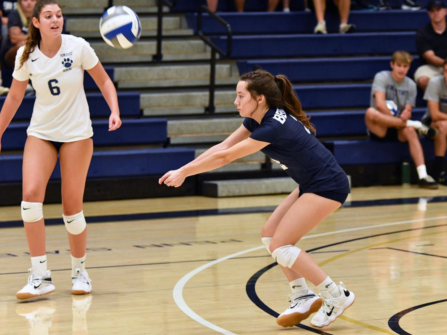 A Penn State Behrend women's volleyball player hits a dig.