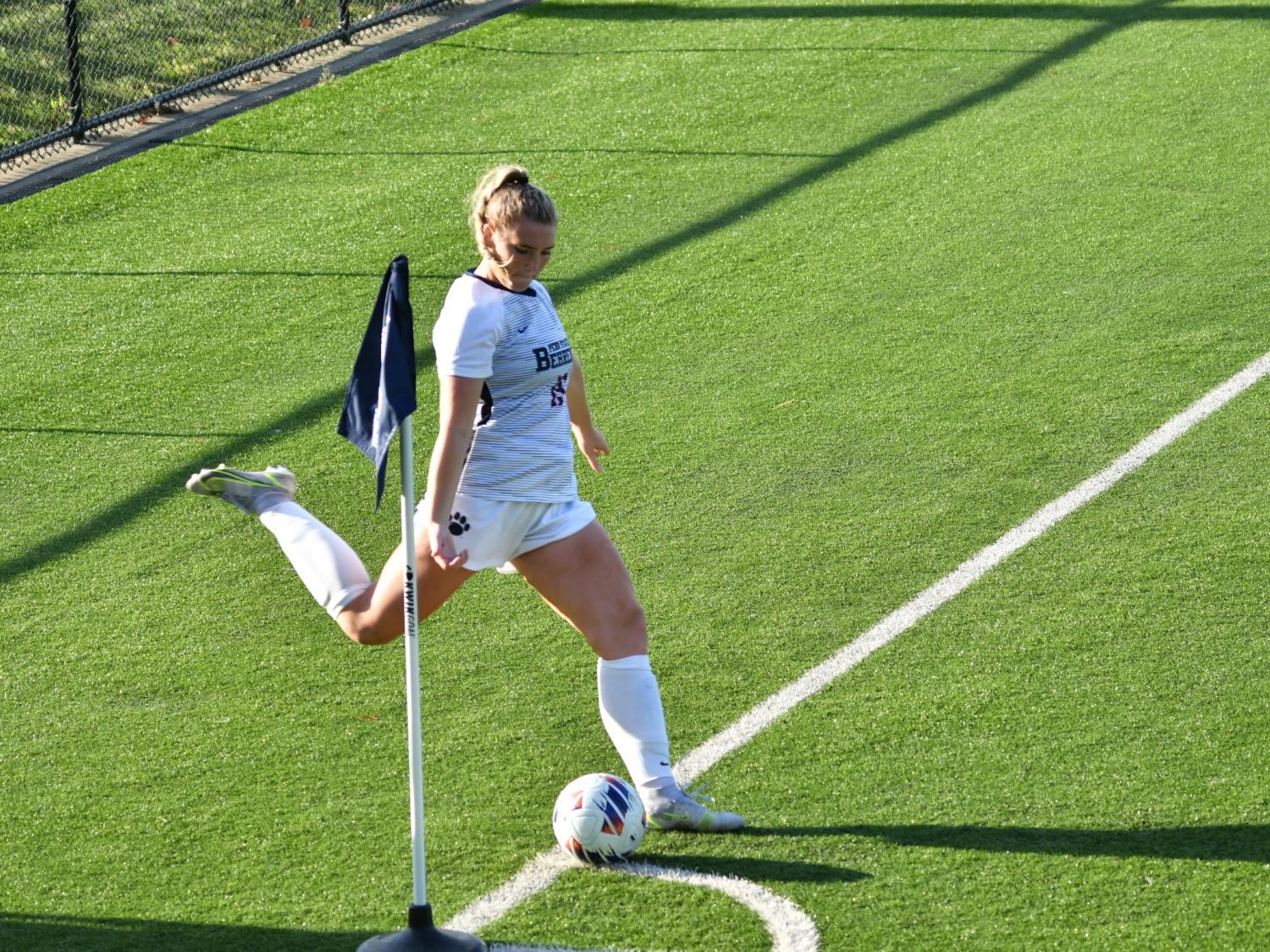 A Penn State Behrend women's soccer player prepares to kick a corner kick.