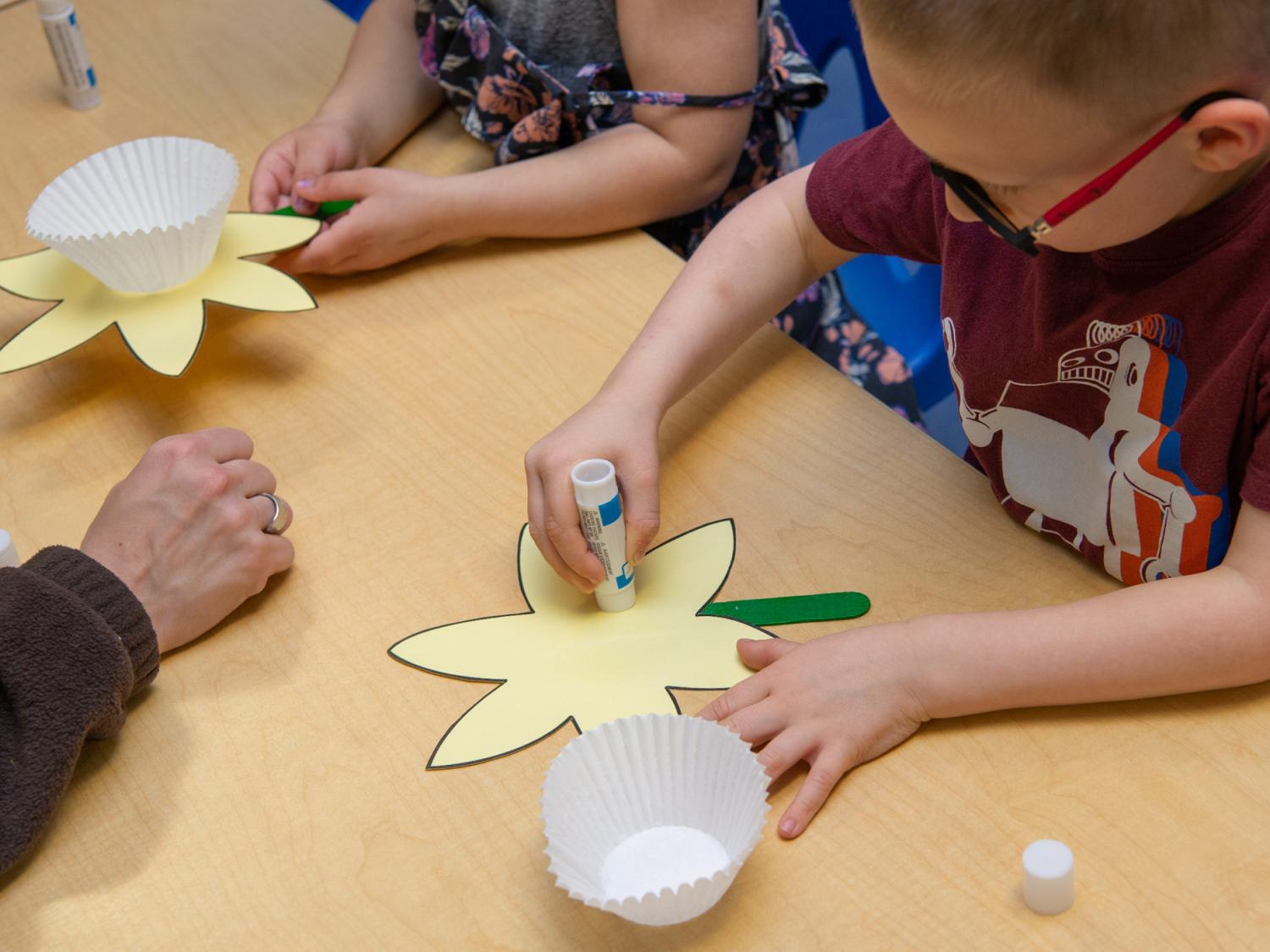 Children make flowers as part of an art project