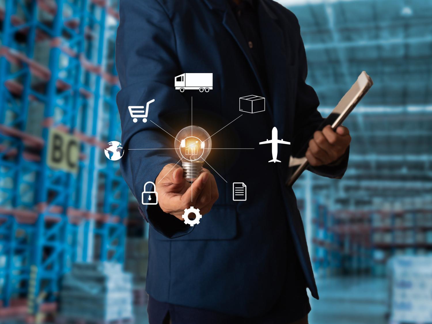 Man in suit holding tablet and lightbulb 