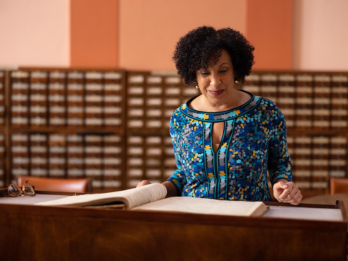 Image of P. Gabrielle Foreman standin in front of library catalog