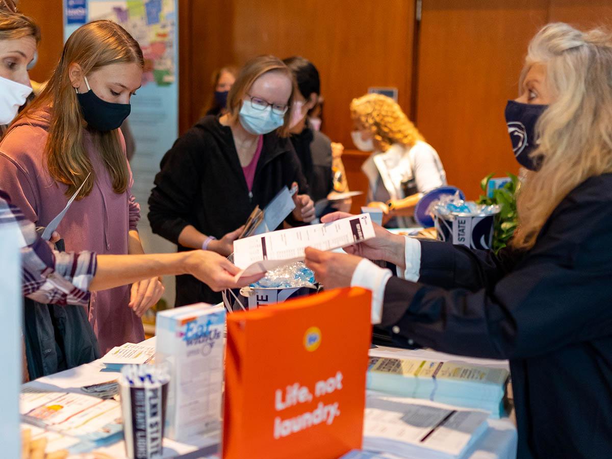 Person showing a brochure to a student