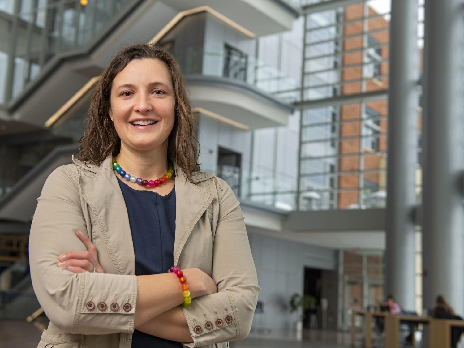 A photo of Karen Winterich standing with her arms crossed in the Business Building Atrium.