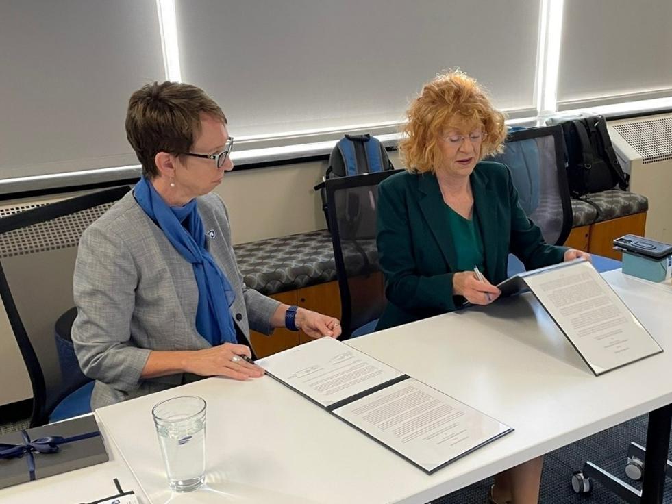 Two women reading over documents