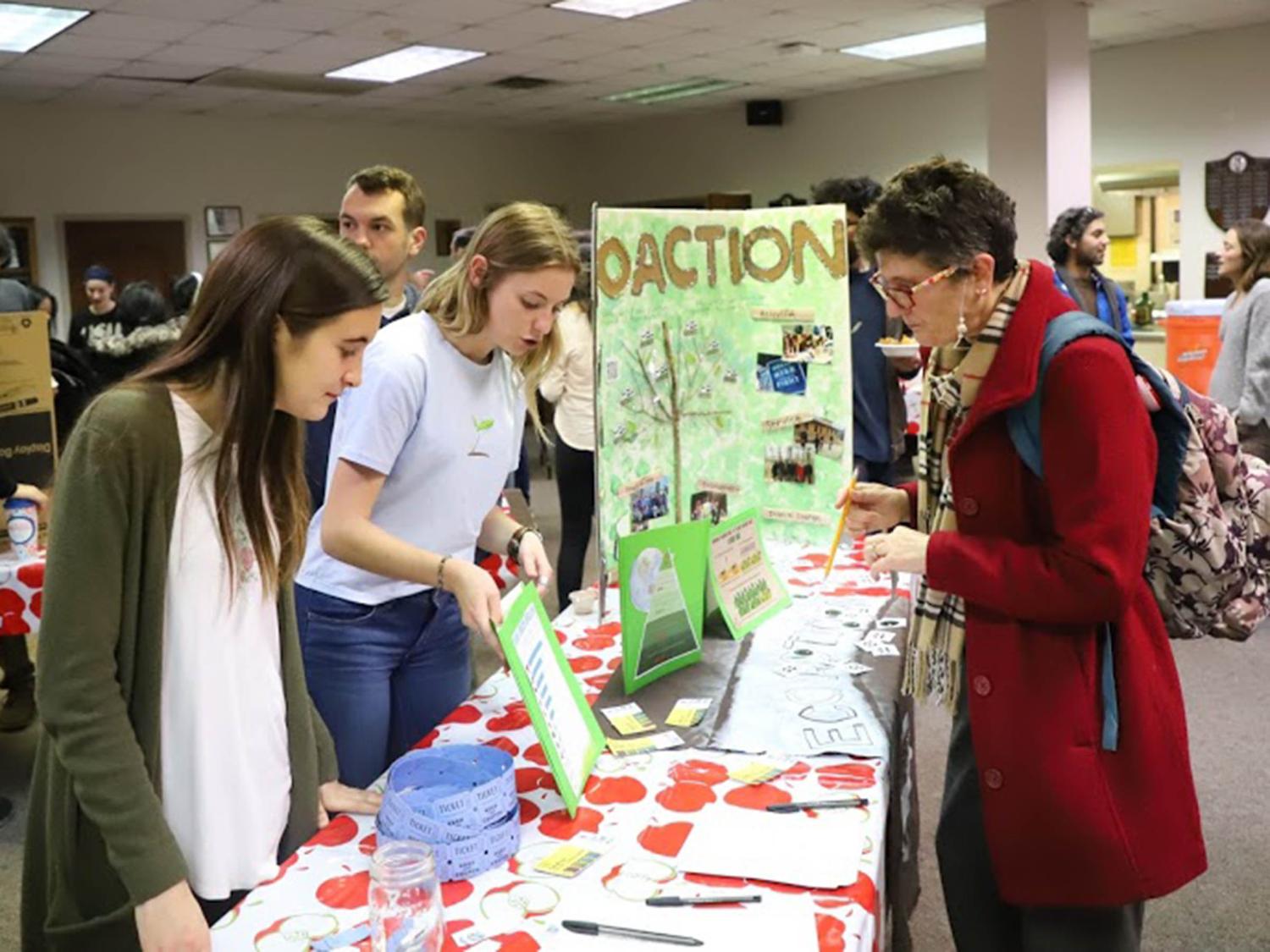 students talking to a guest across a table