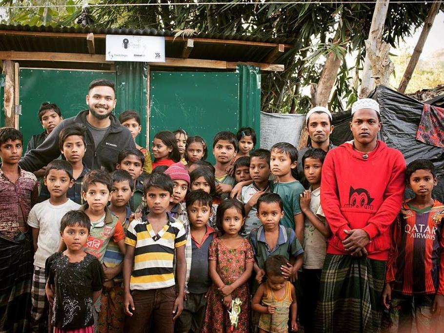 A man standing with a group of children