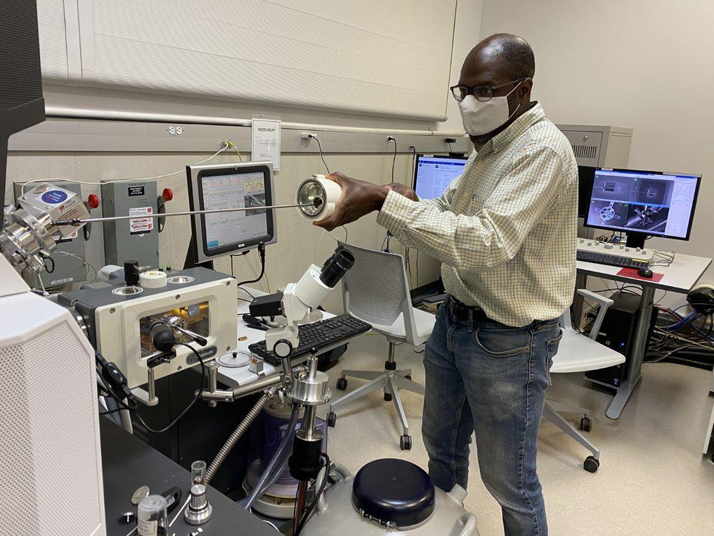 man loading a sample into a lab machine