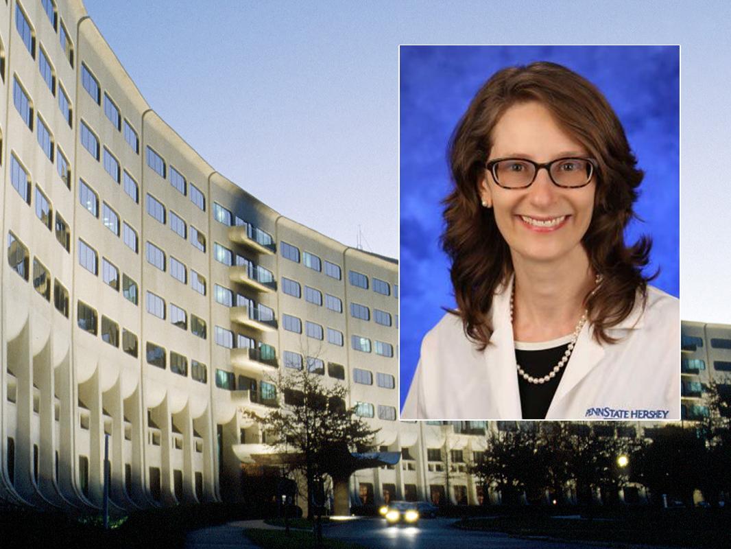 A head and shoulders professional portrait of Dr. Erika Saunders against a background image of Penn State College of Medicine.